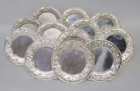 Set of twelve sterling silver repoussé bread plates s. kirk & son, baltimore, md, 20th century