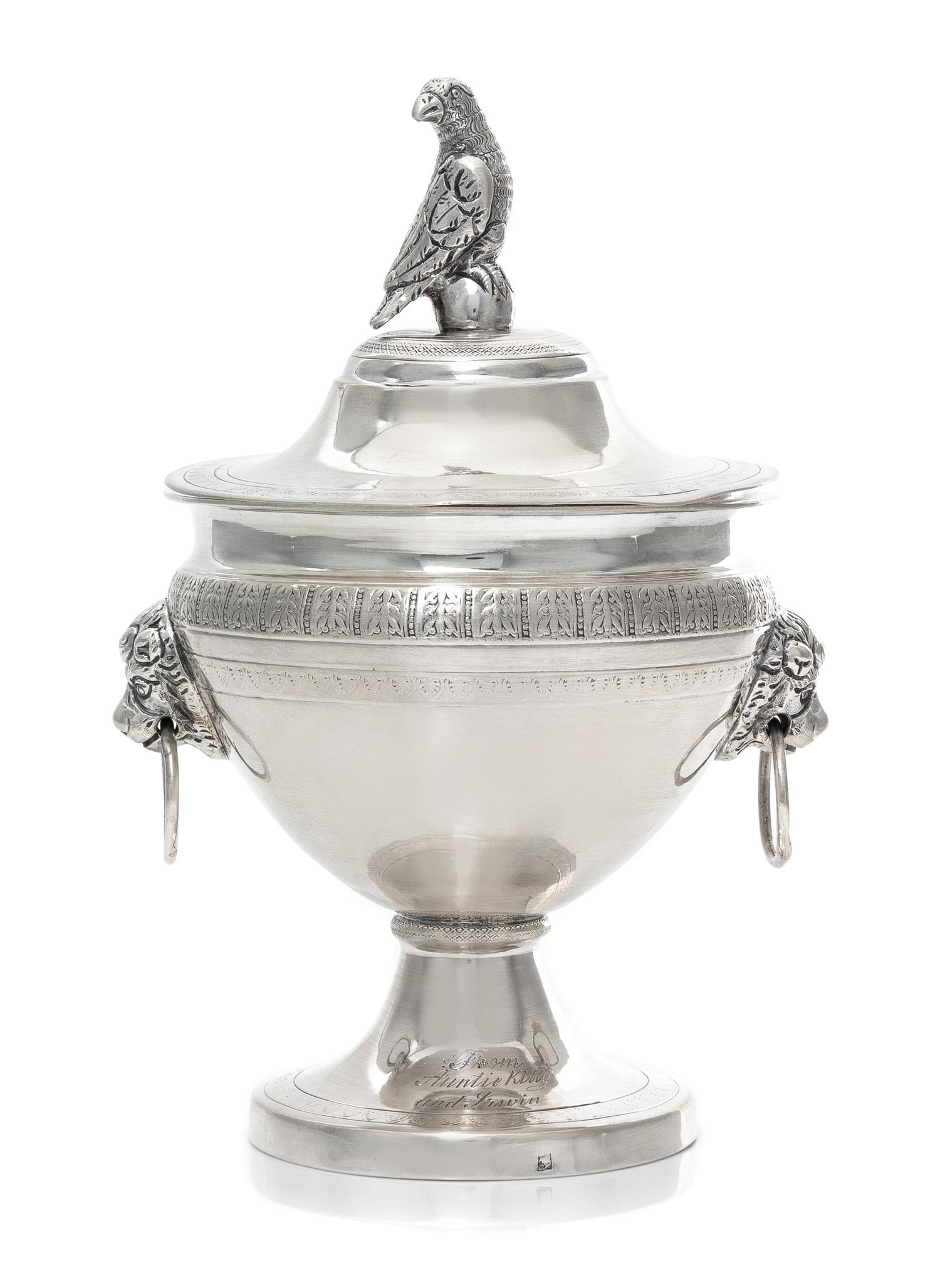 A Continental Silver Covered Sugar, 19th Century, the lid with a bird form finial, the body with mask ring handles.