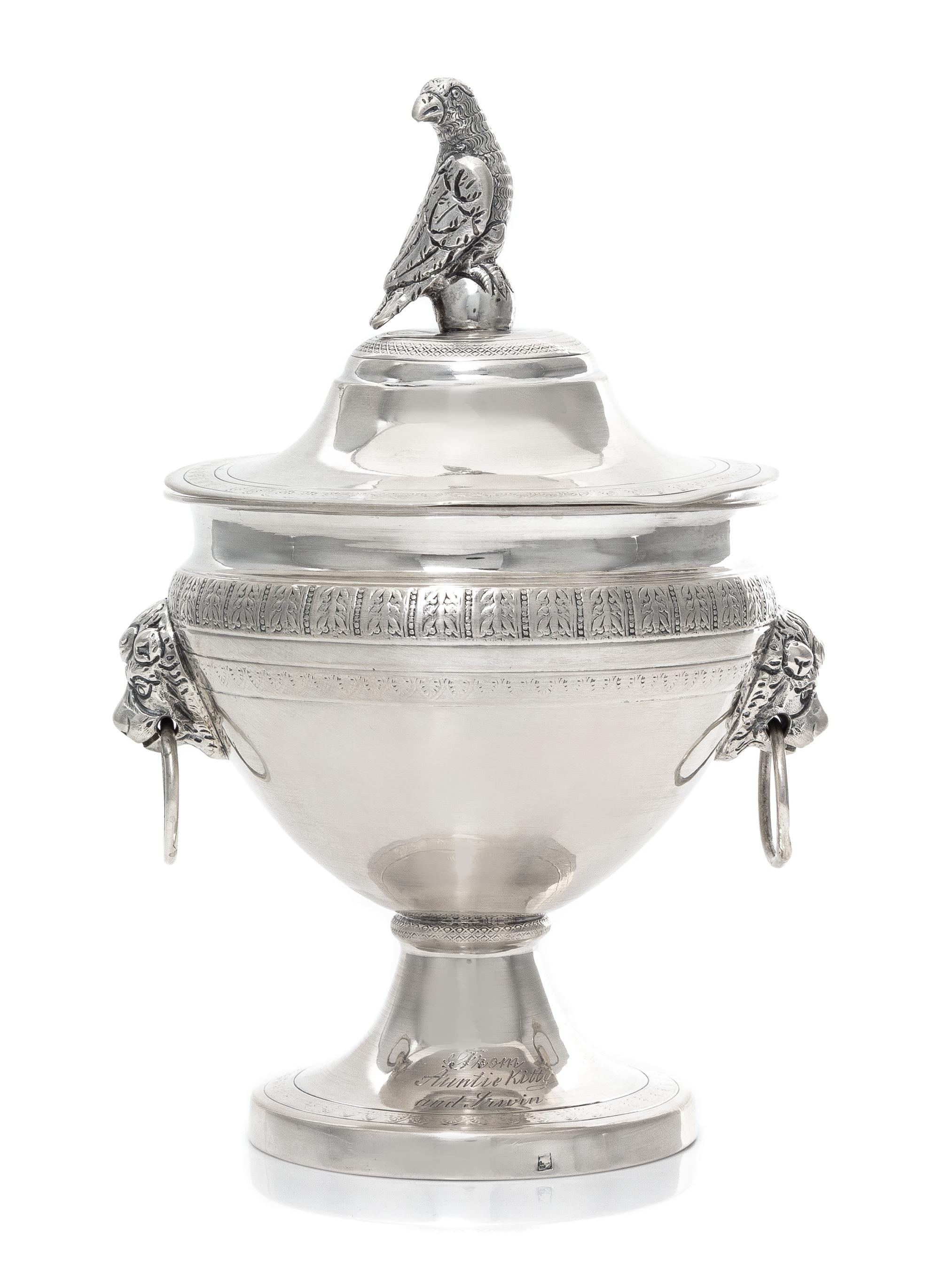 A Continental Silver Covered Sugar, 19th Century, the lid with a bird form finial, the body with mask ring handles.