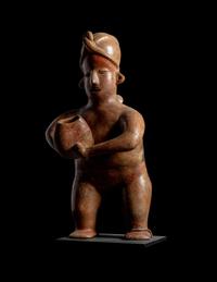 A Colima Standing Figure Holding a Pot