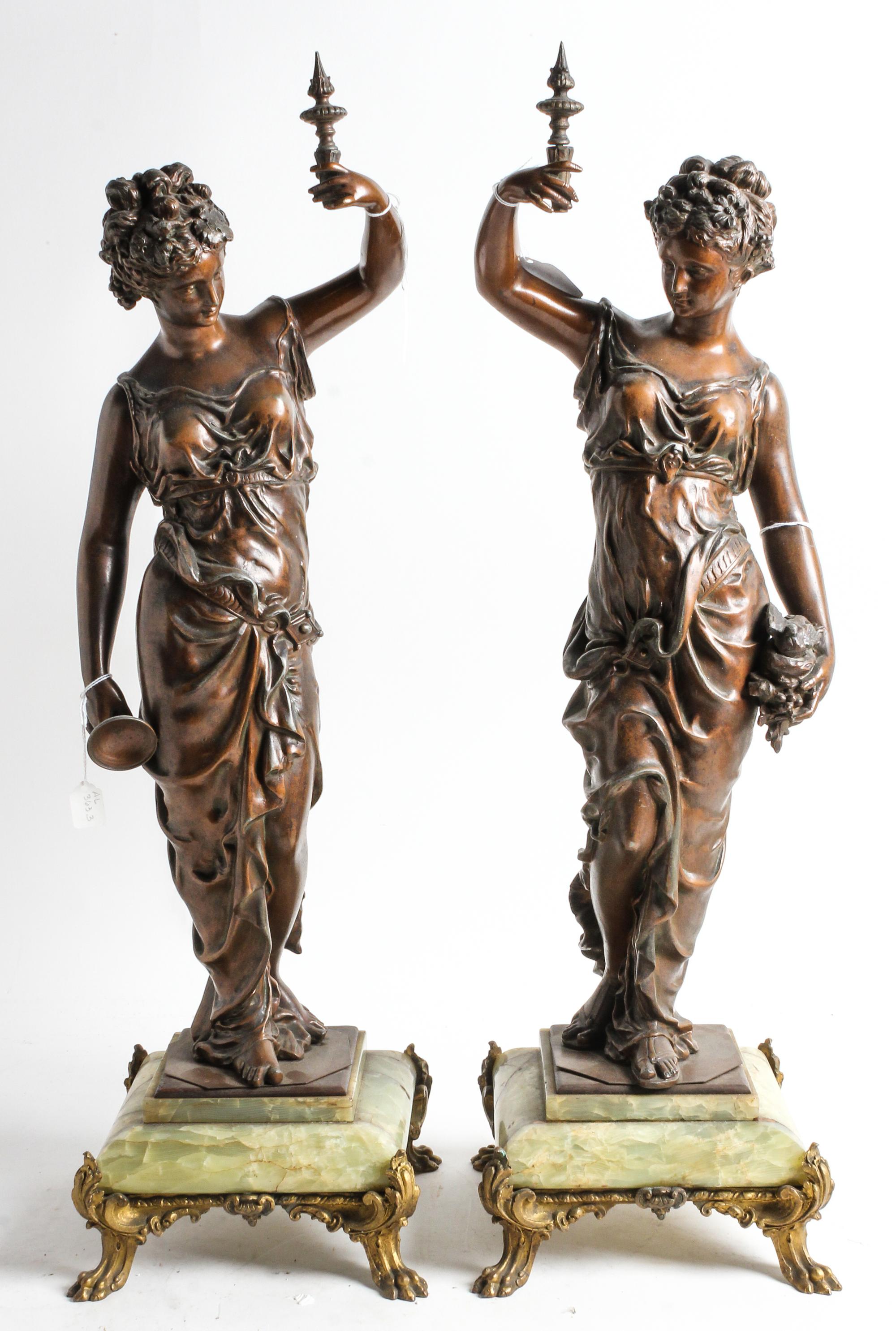 A Pair of Continental Cast Metal and Onyx Figures Height 28 inches. — EARLY 20TH CENTURY