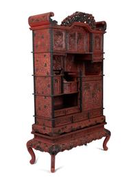 A Chinese Export Carved Red Lacquer Curio Cabinet — EARLY 20TH CENTURY