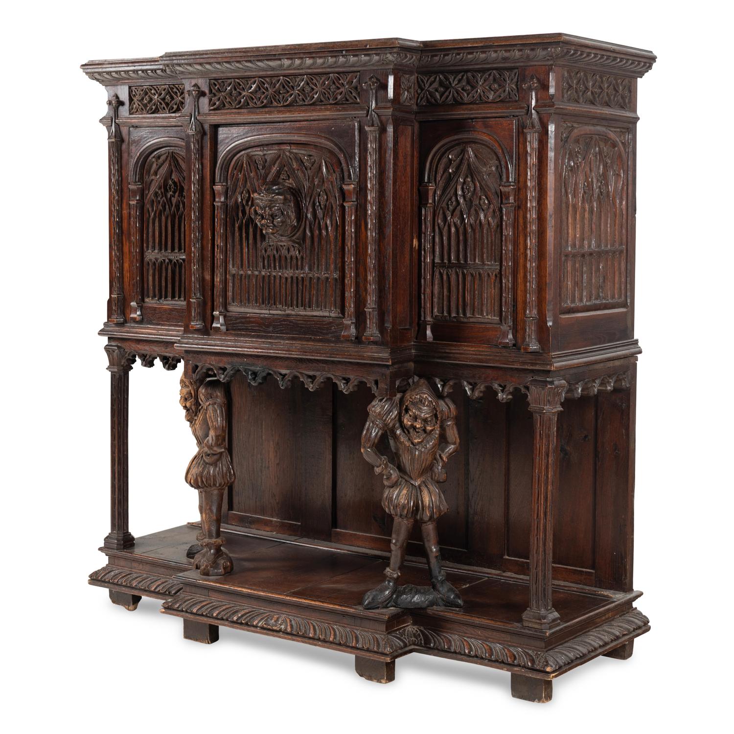 A Gothic Revival Carved Oak Court Cupboard