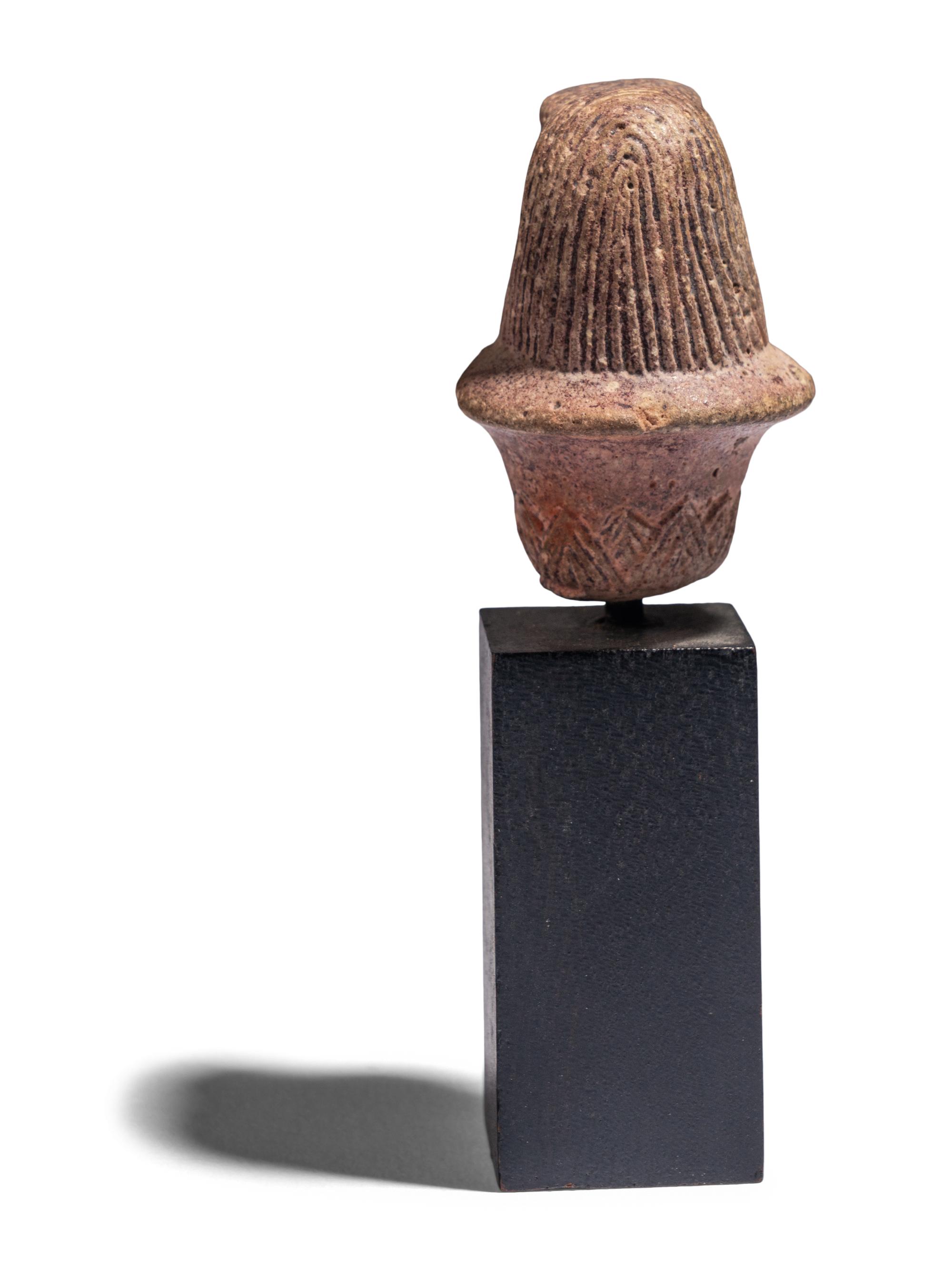 An Egyptian Stone Wadj Fragment with the Head of a Falcon