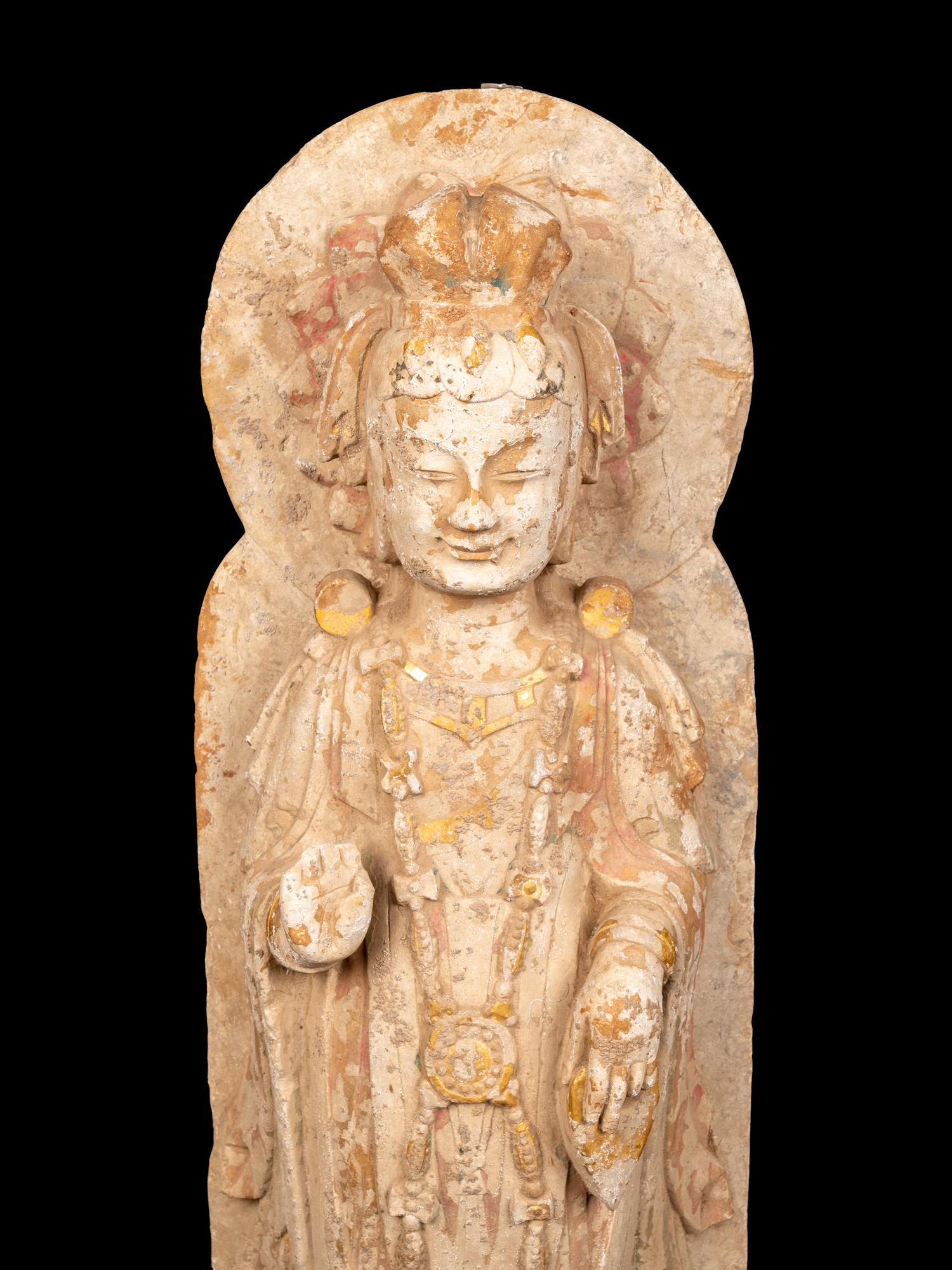 A Chinese Carved Stone Standing Buddha with Remnants of Gilt on Lotus-Form Base