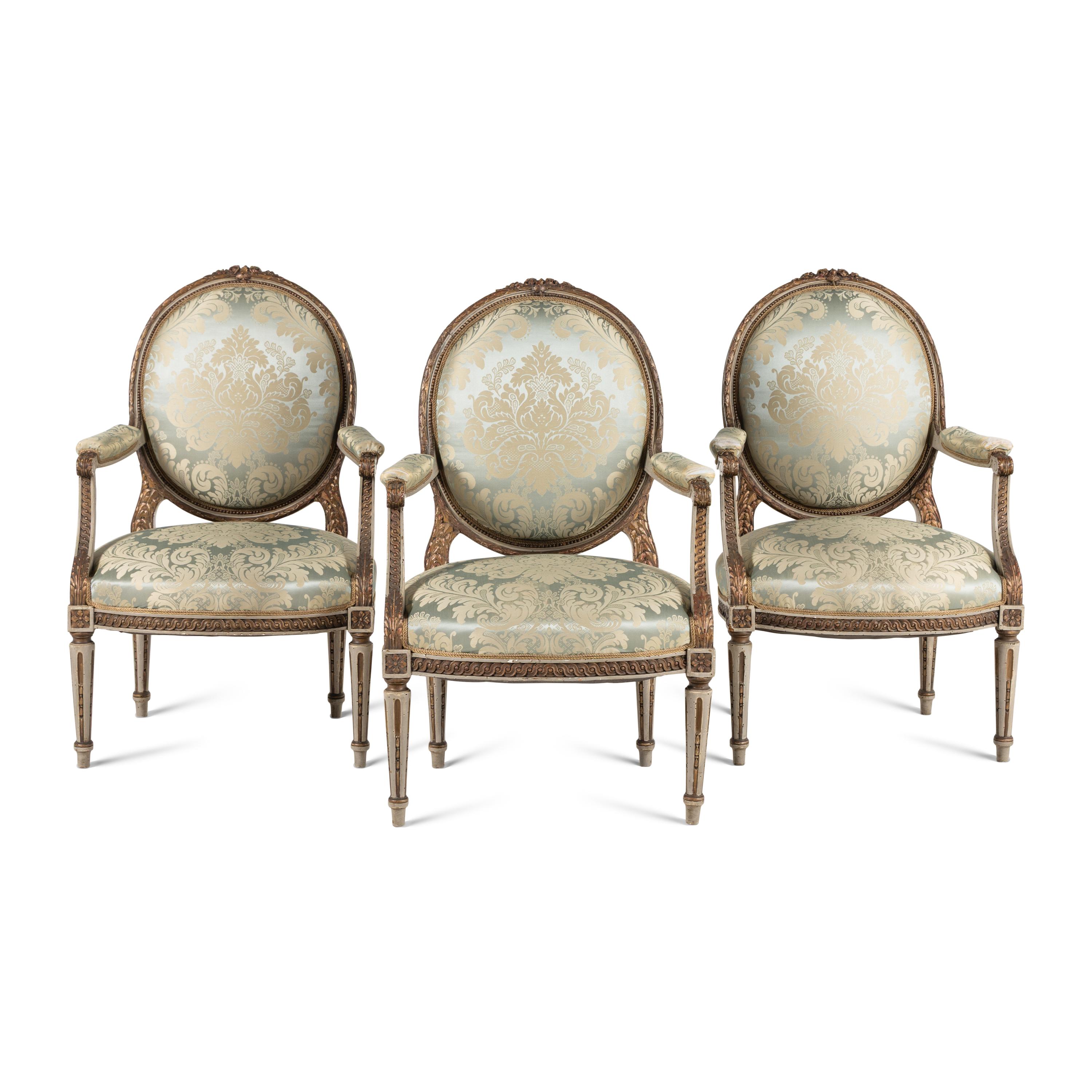 A Set Three of Louis XVI Style Grey-Painted and Parcel Gilt Fauteuils