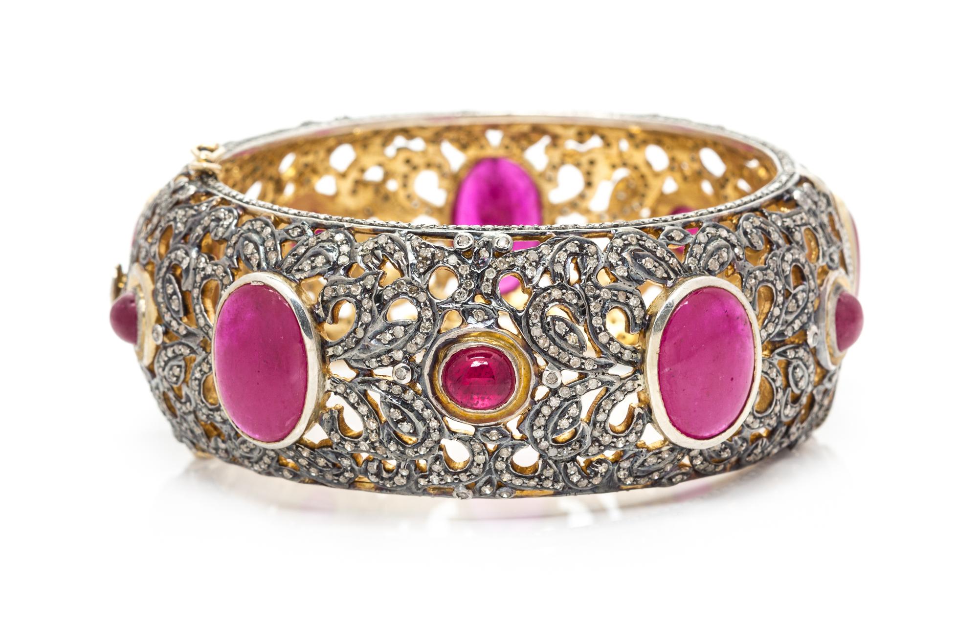 A Silver Topped Gold, Treated Ruby and Diamond Bangle Bracelet, 53.00 dwts.
