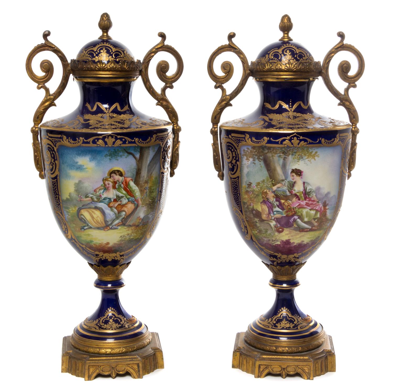A Pair of Sevres Style Gilt Bronze Mounted Porcelain Urns Height 15 3/8 inches.