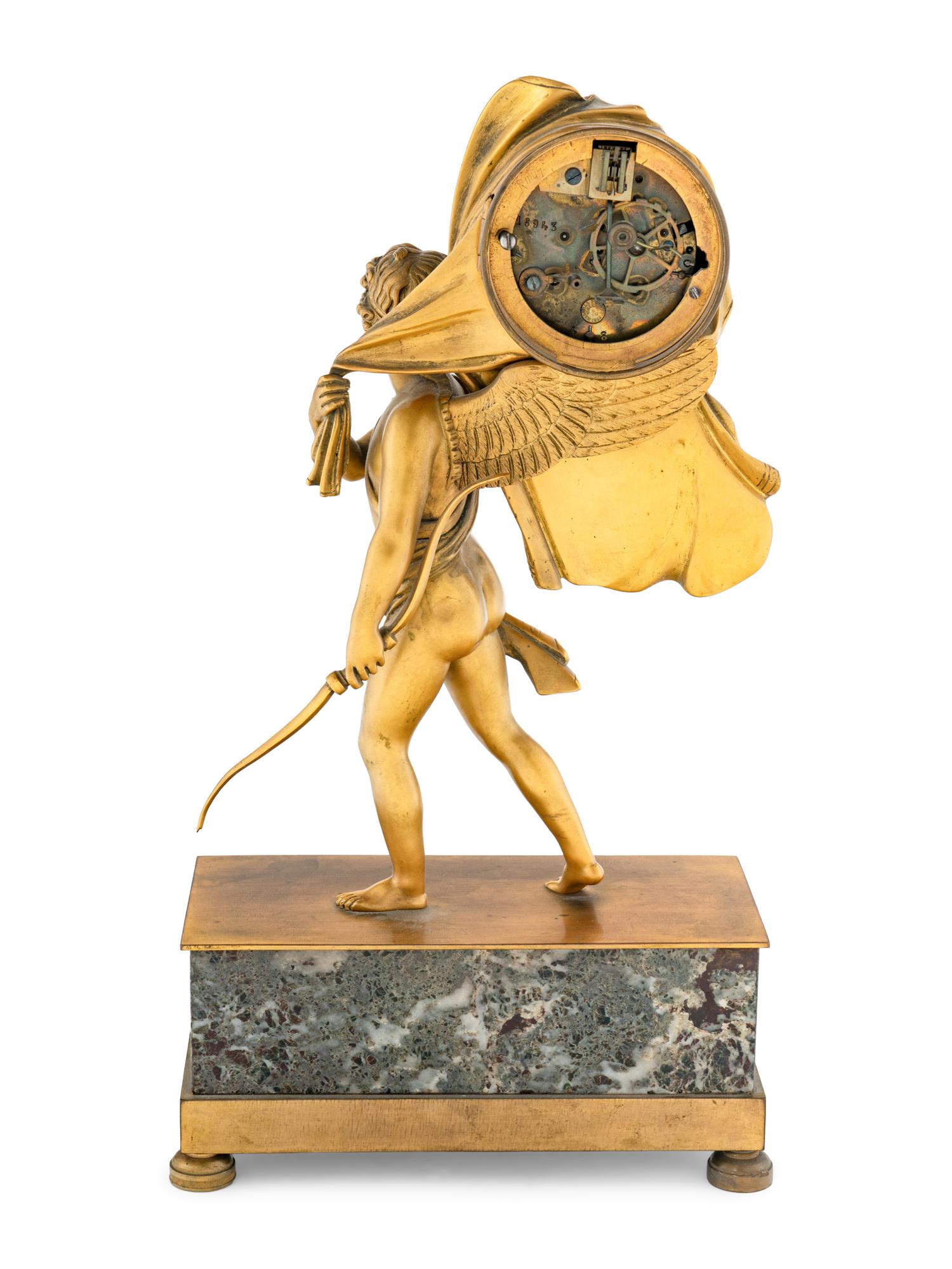 An Empire Style Gilt Bronze and Marble Figural Clock