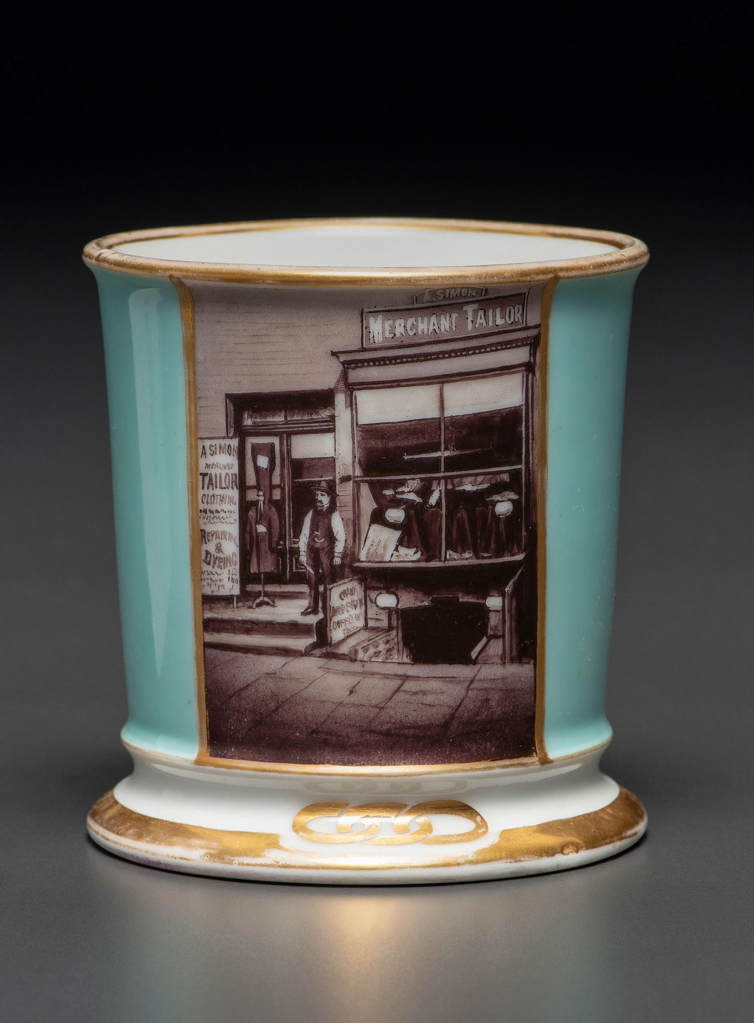 A Paint Enhanced Photographic Transfer Porcelain Occupational Shaving Mug Depicting a Tailor's Shop