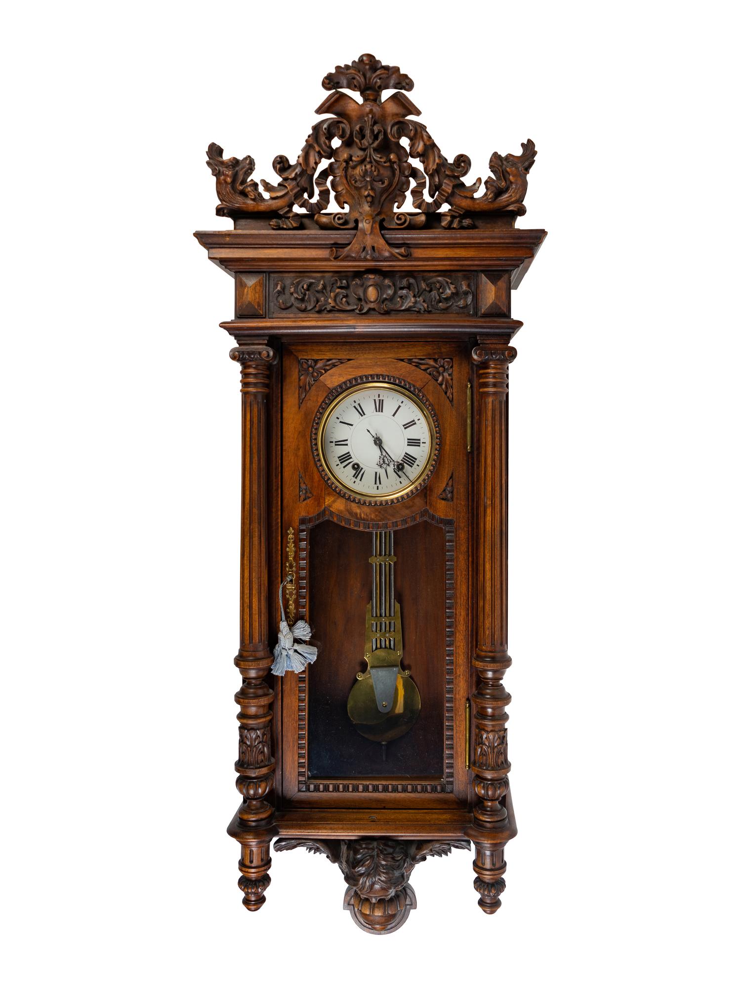 A Renaissance Revival Carved Walnut Regulator Clock