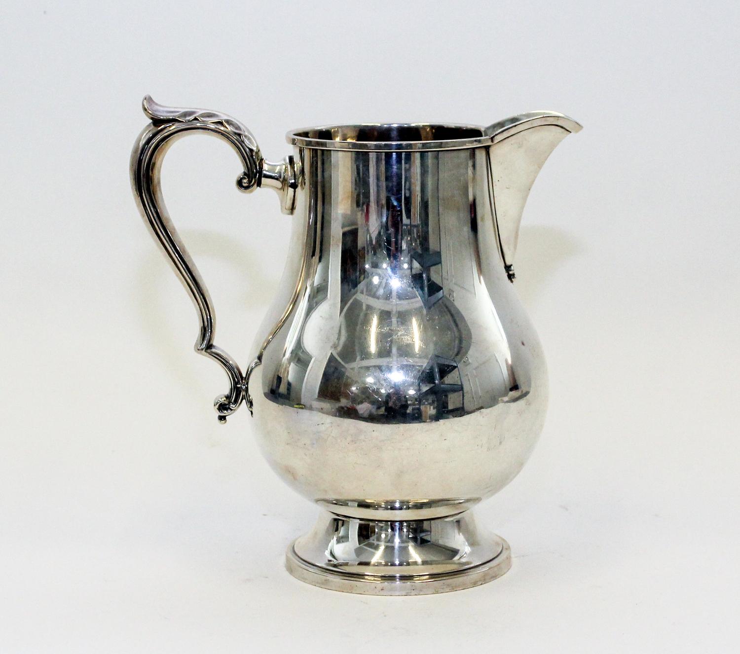 An American Silver Water Pitcher, M. Fred Hirsch Co., Jersey City, NJ, of baluster form, raised on a circular foot.