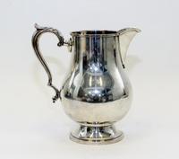 An American Silver Water Pitcher, M. Fred Hirsch Co., Jersey City, NJ, of baluster form, raised on a circular foot.