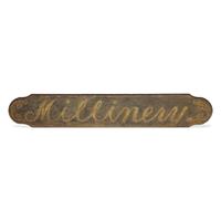 A Painted Wood "Millinery" Trade Sign