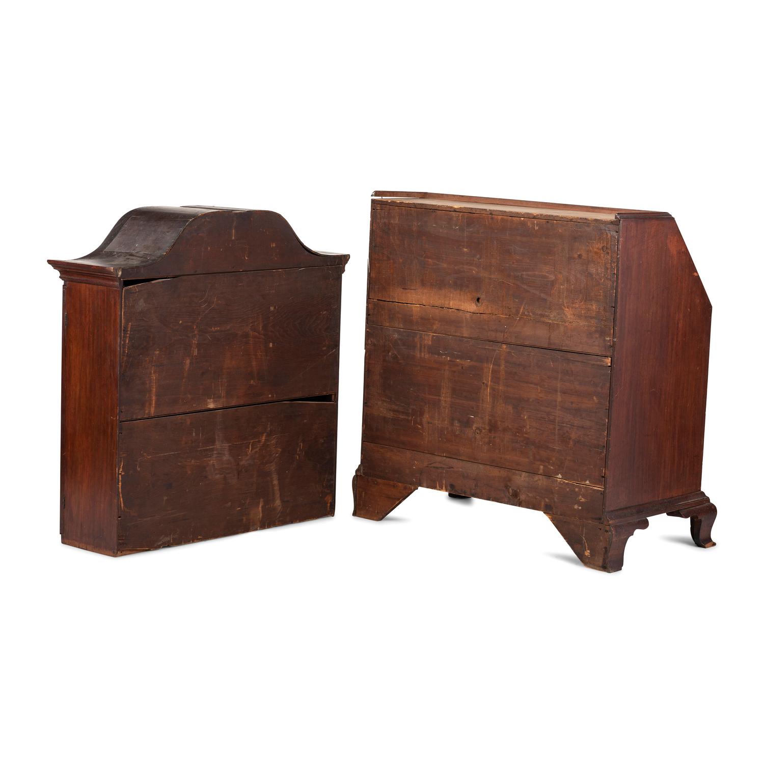 A Chippendale Carved and Paneled Mahogany Slant-Front Desk-and-Bookcase