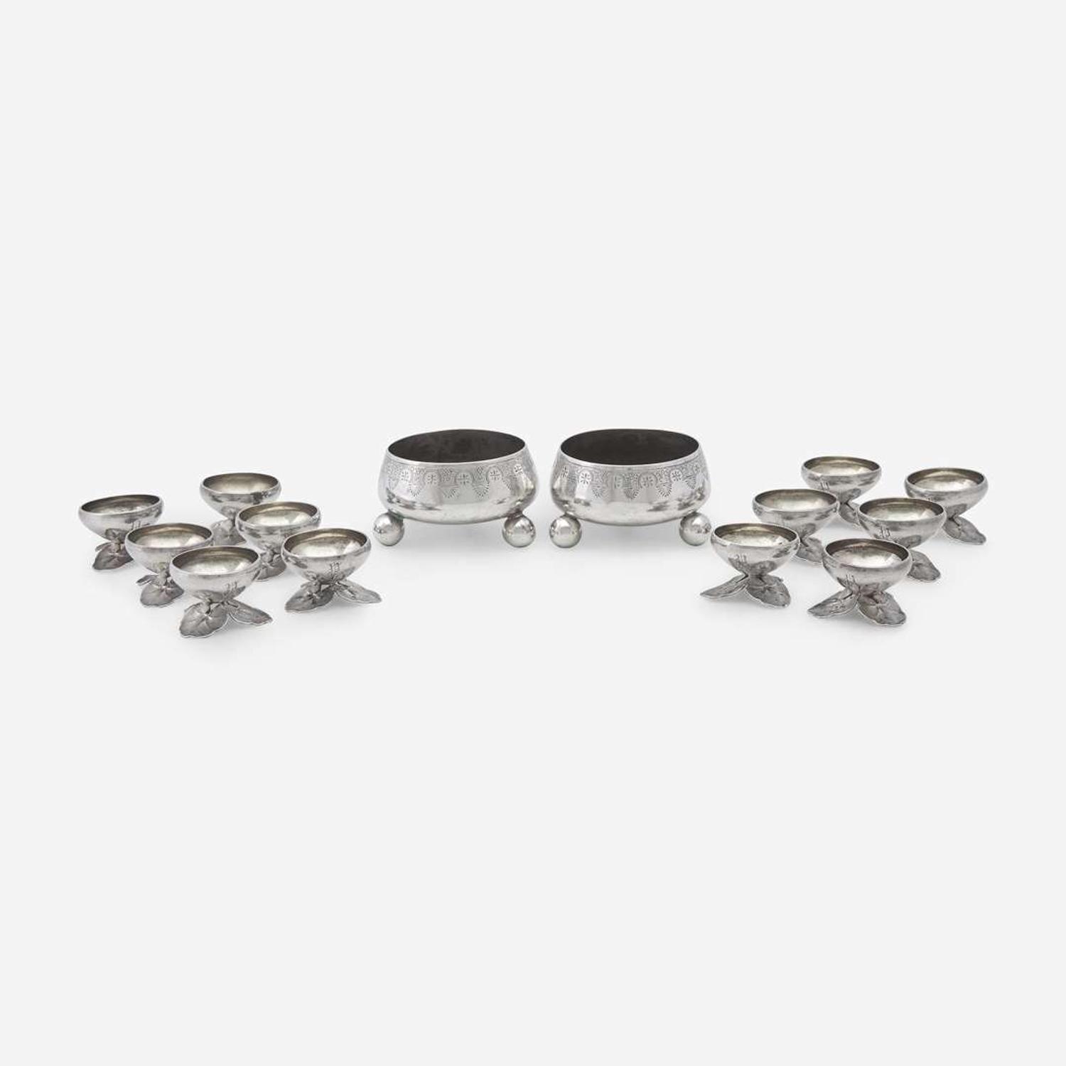 A pair of Néo-Grec sterling silver master salts and a set of twelve silver salt cellars with lily pad feet Tiffany & Co., New York, NY, 1875-1891, and other