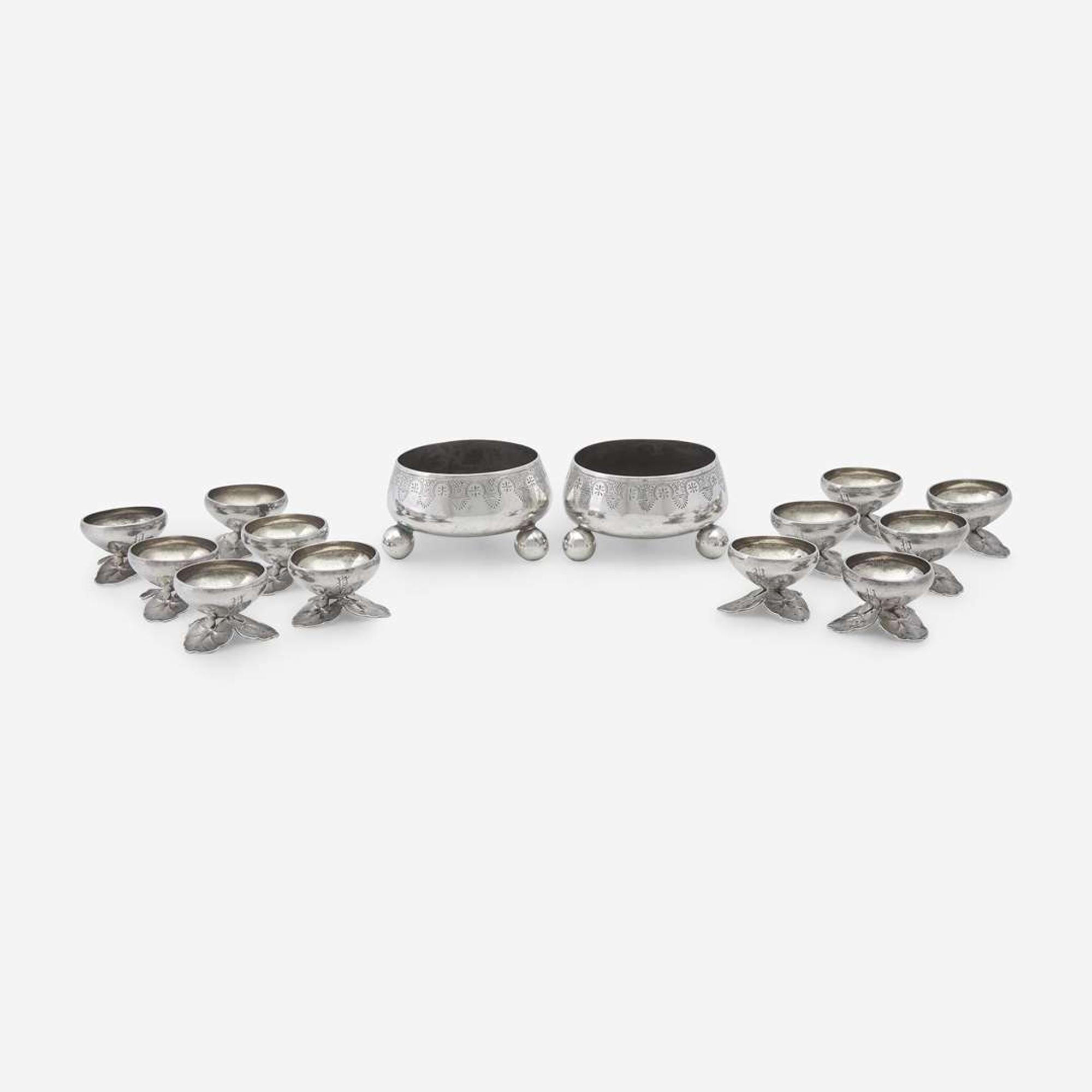 A pair of Néo-Grec sterling silver master salts and a set of twelve silver salt cellars with lily pad feet Tiffany & Co., New York, NY, 1875-1891, and other