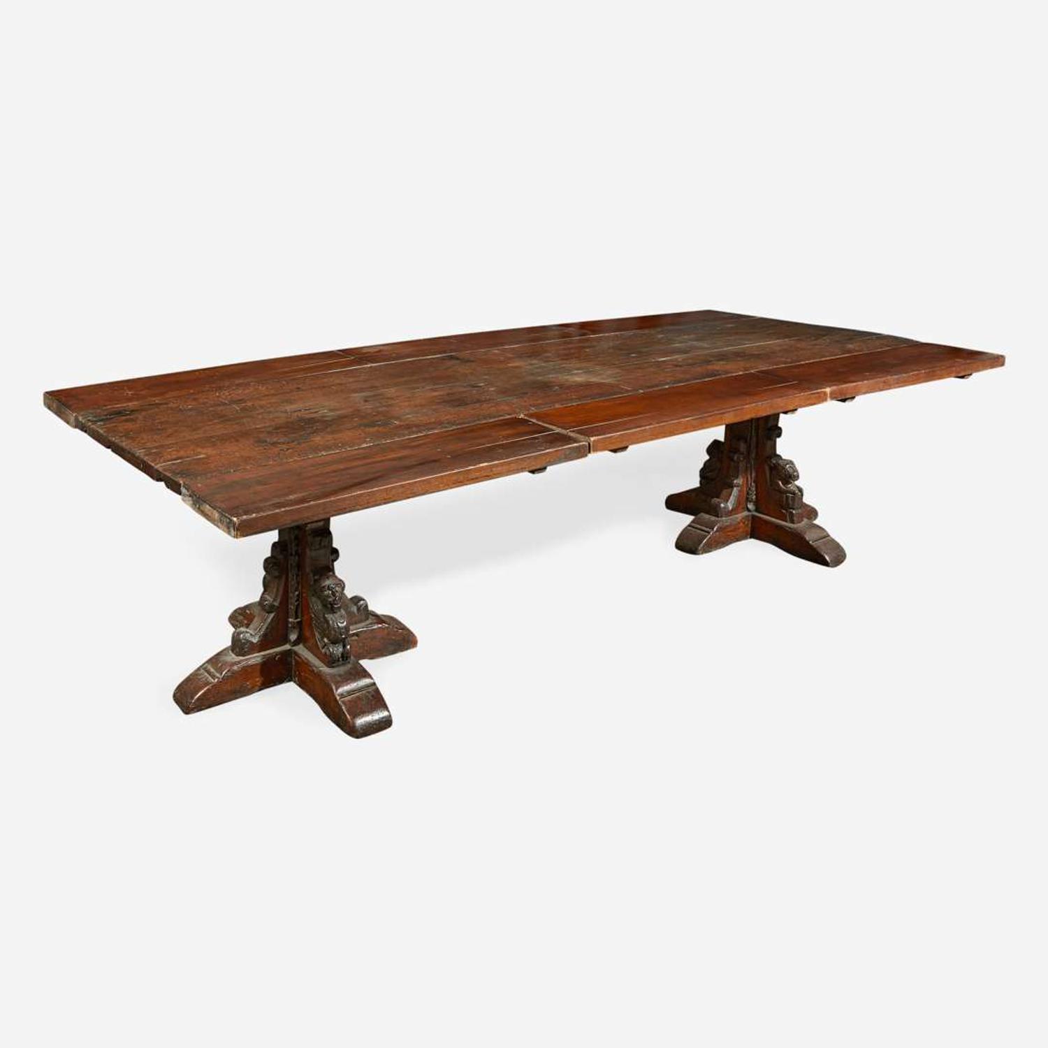 A Gothic Revival carved oak dining table composed of elements likely dating to the 17th century and later