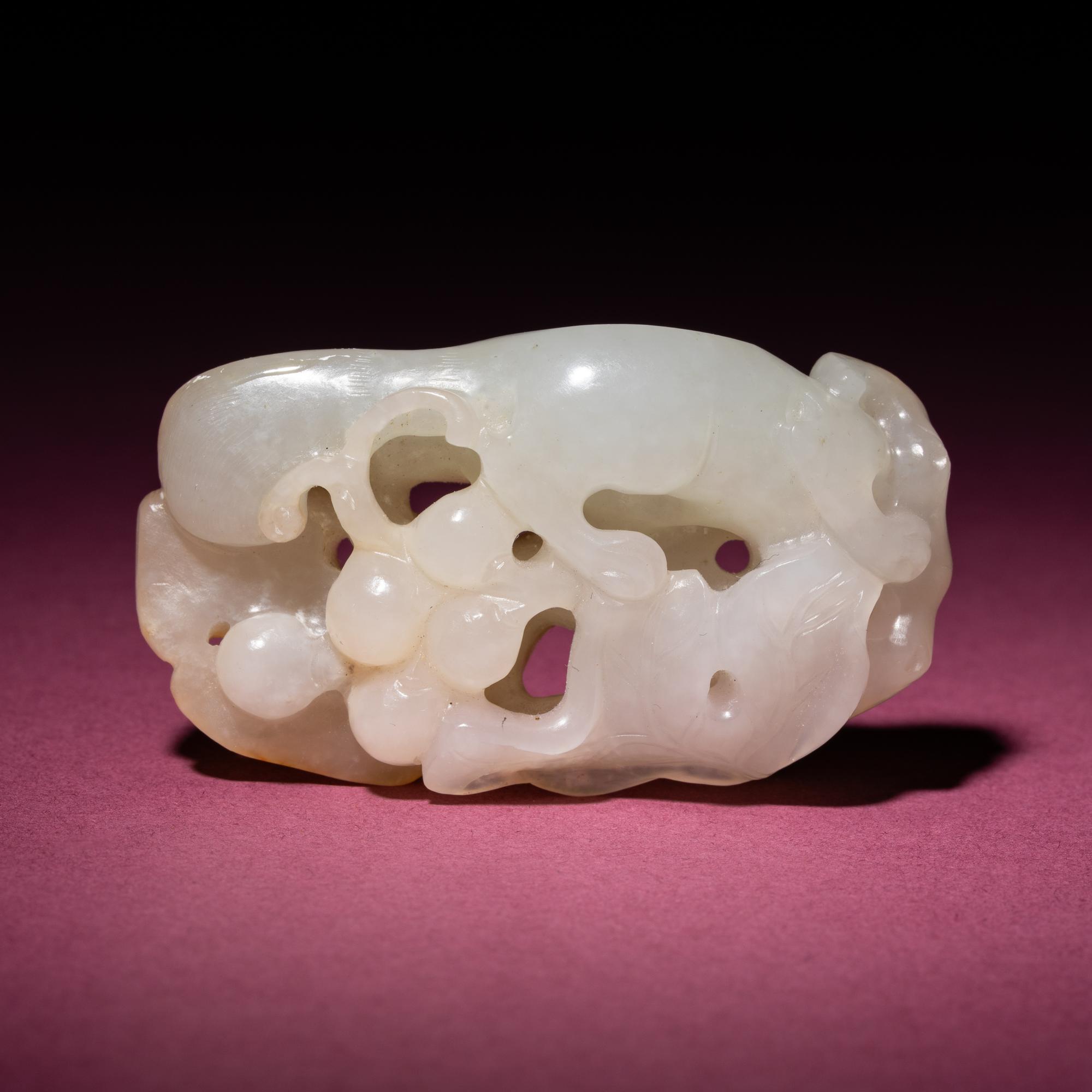 A Chinese Russet and White Jade 'Squirrel and Grape' Carving, 18th/19th Century — 清中期 白玉留皮松鼠葡萄