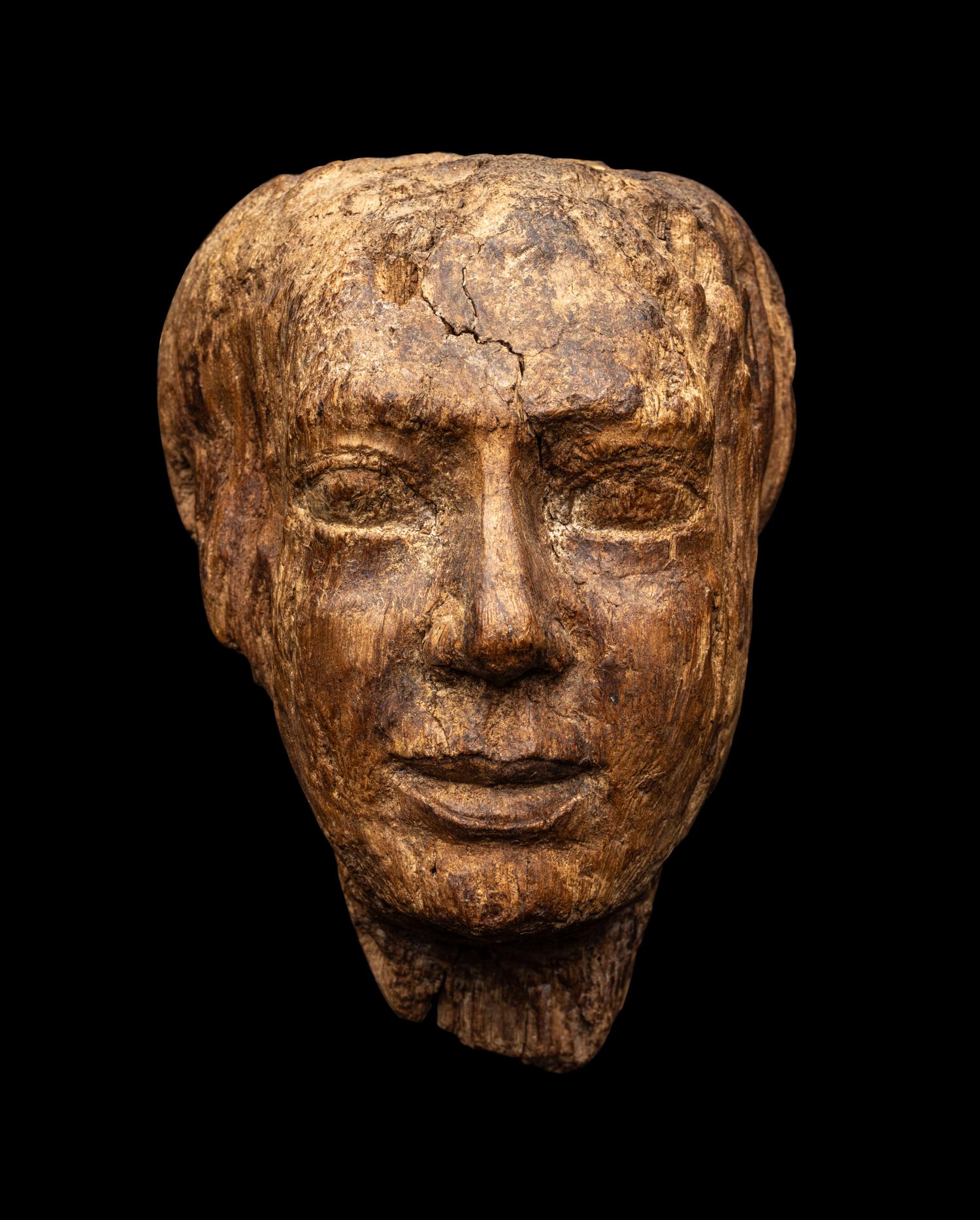 An Egyptian Wood Head of a Priest