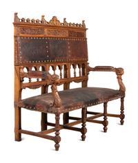An Austrian Carved Walnut Bench with Tooled Leather Upholstery
