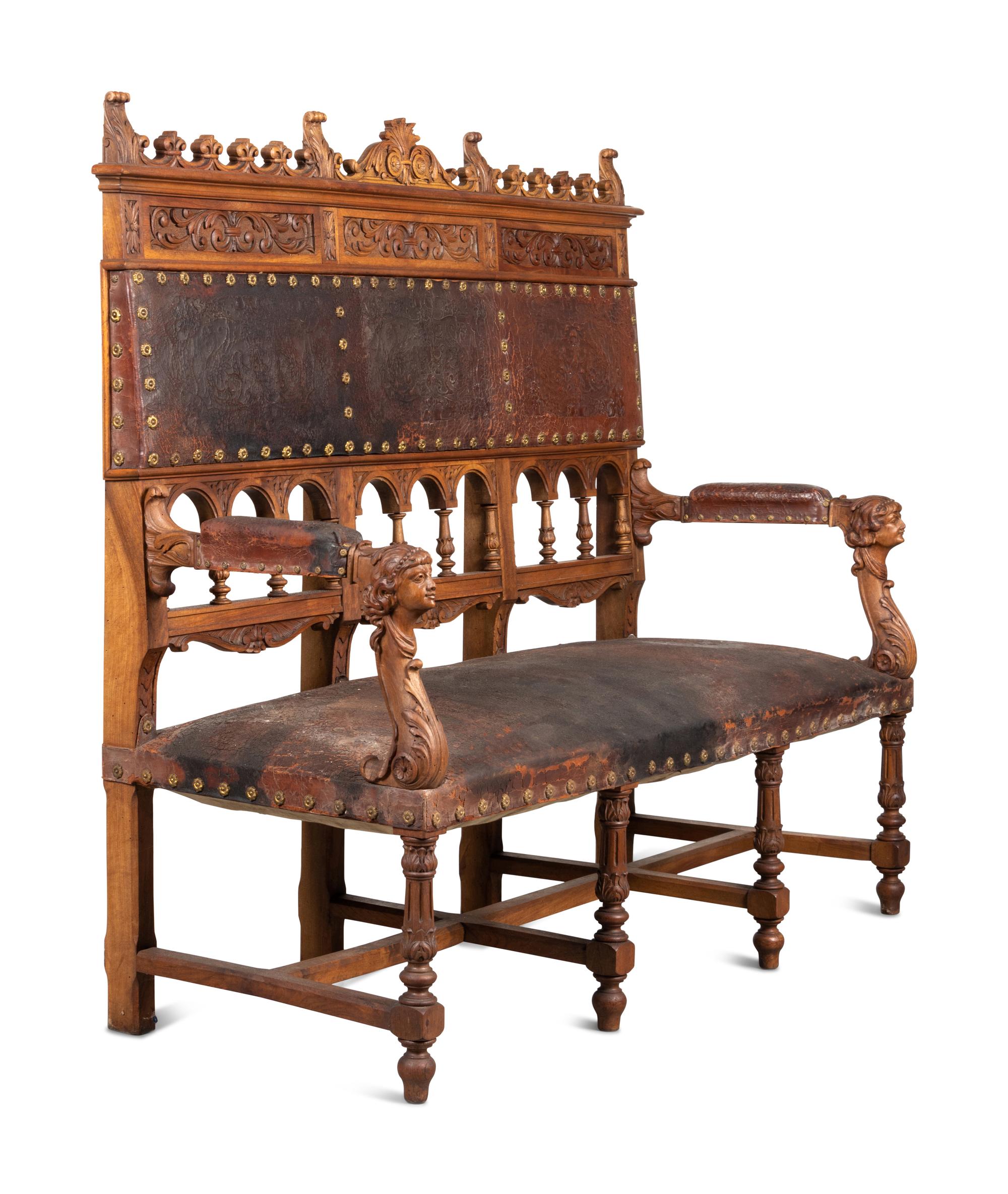 An Austrian Carved Walnut Bench with Tooled Leather Upholstery