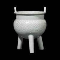 A Chinese Qingbai Style Molded Tripod Censor, Yuan Dynasty or Later 元或更晚 白釉如意紋瓷鼎