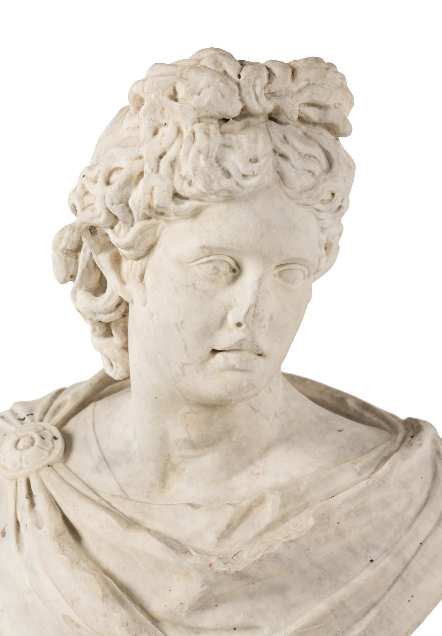 A Continental Carved Marble Bust of the Apollo Belvedere
