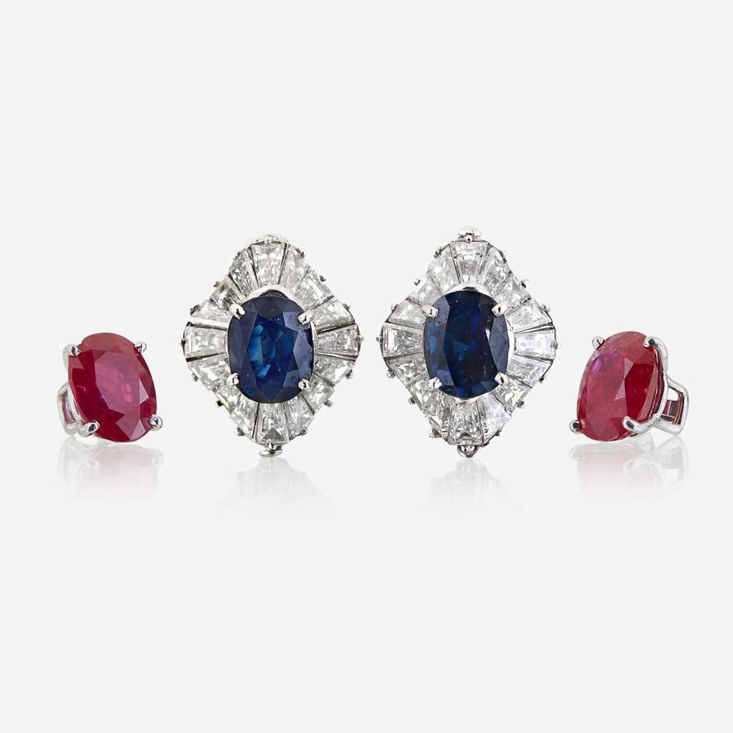 A pair of diamond and platinum earring jackets with interchangeable ruby and sapphire studs