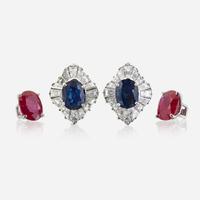 A pair of diamond and platinum earring jackets with interchangeable ruby and sapphire studs