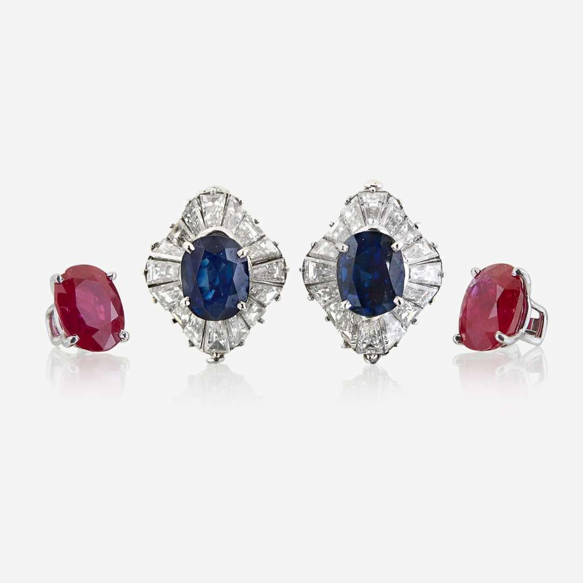 A pair of diamond and platinum earring jackets with interchangeable ruby and sapphire studs