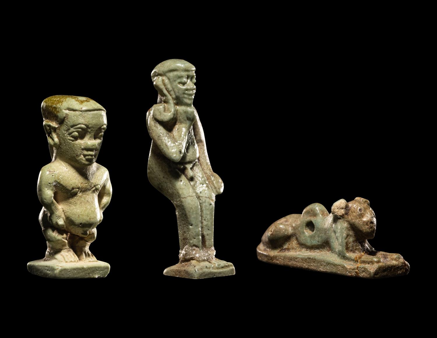 Three Egyptian Faience Amulets Including a Pataikos, a Harpocrates, and a Recumbent Lion