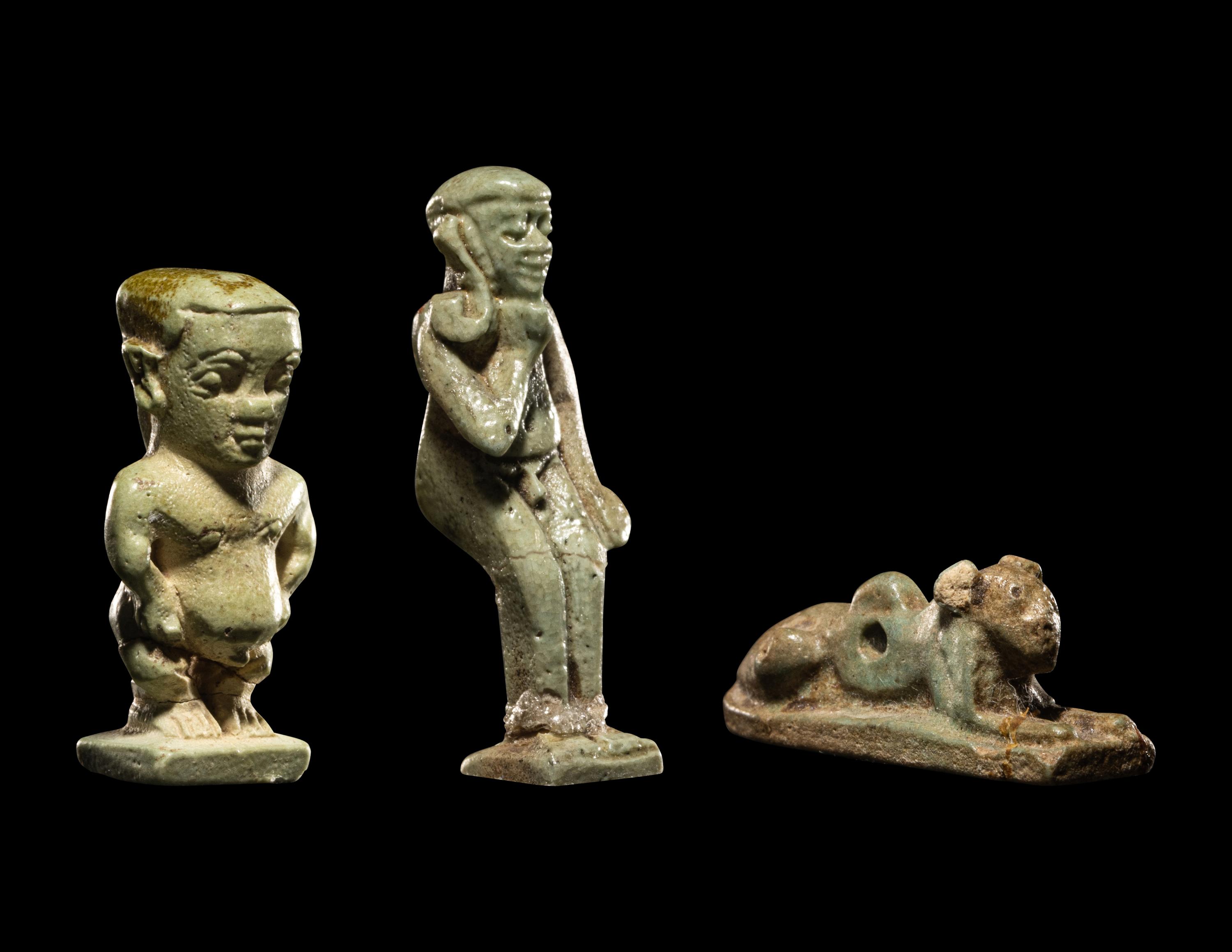 Three Egyptian Faience Amulets Including a Pataikos, a Harpocrates, and a Recumbent Lion