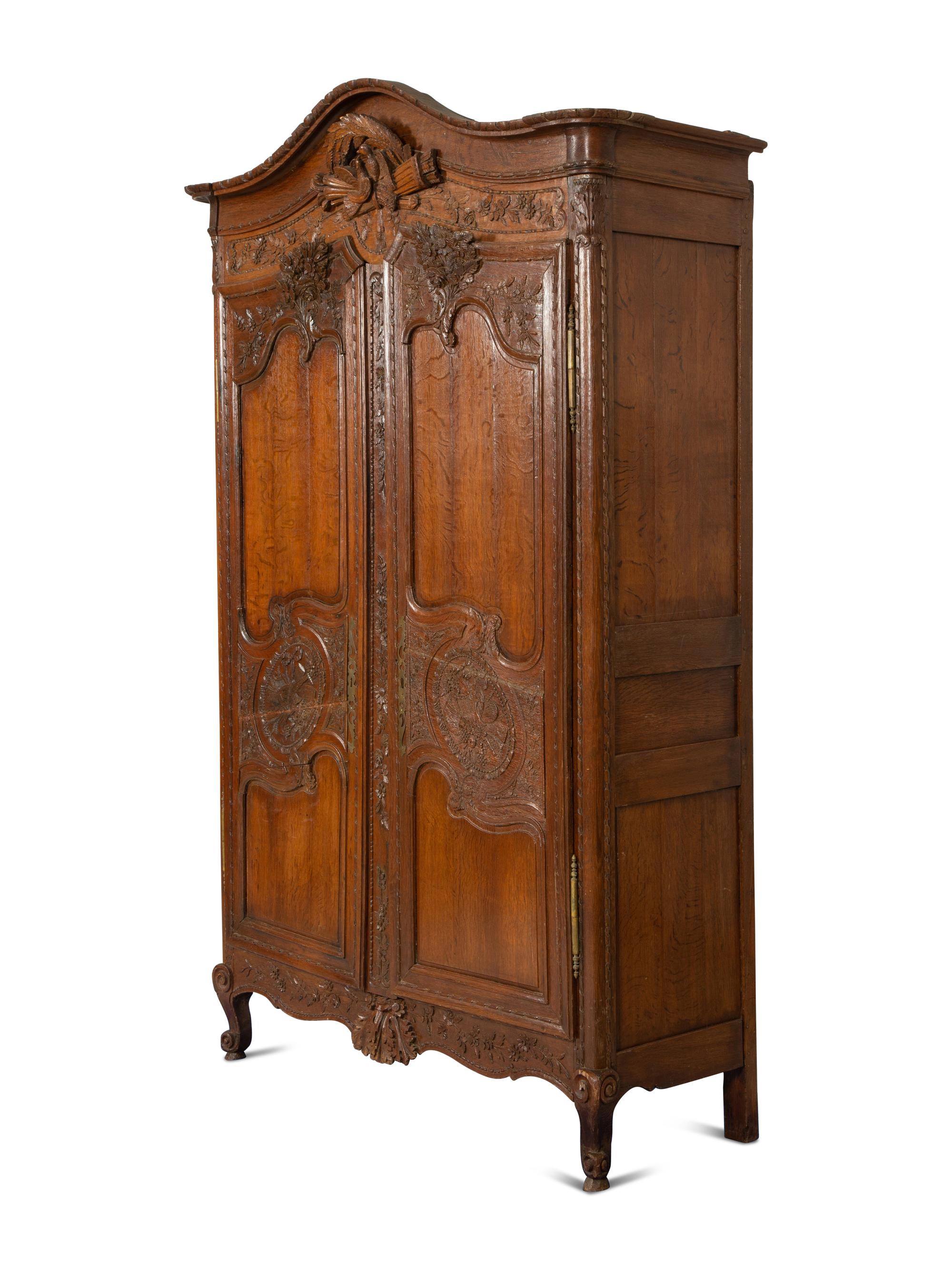 A French Provincial Carved Oak Armoire