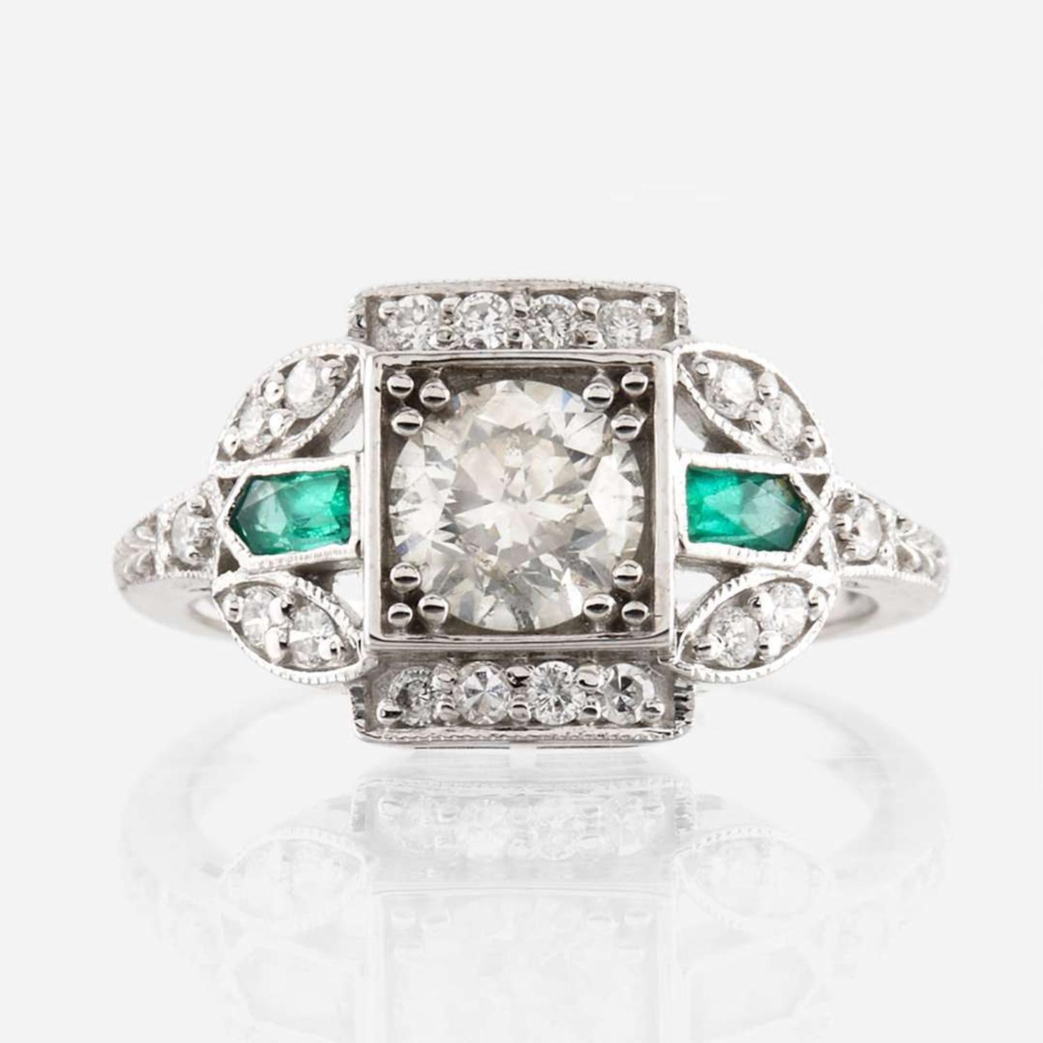 A diamond, emerald, and white gold ring