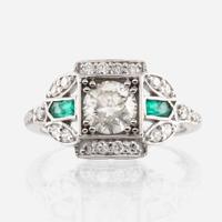 A diamond, emerald, and white gold ring