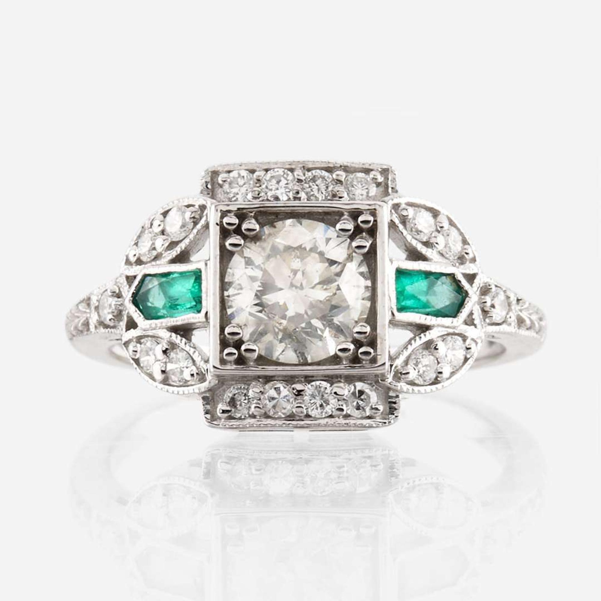A diamond, emerald, and white gold ring