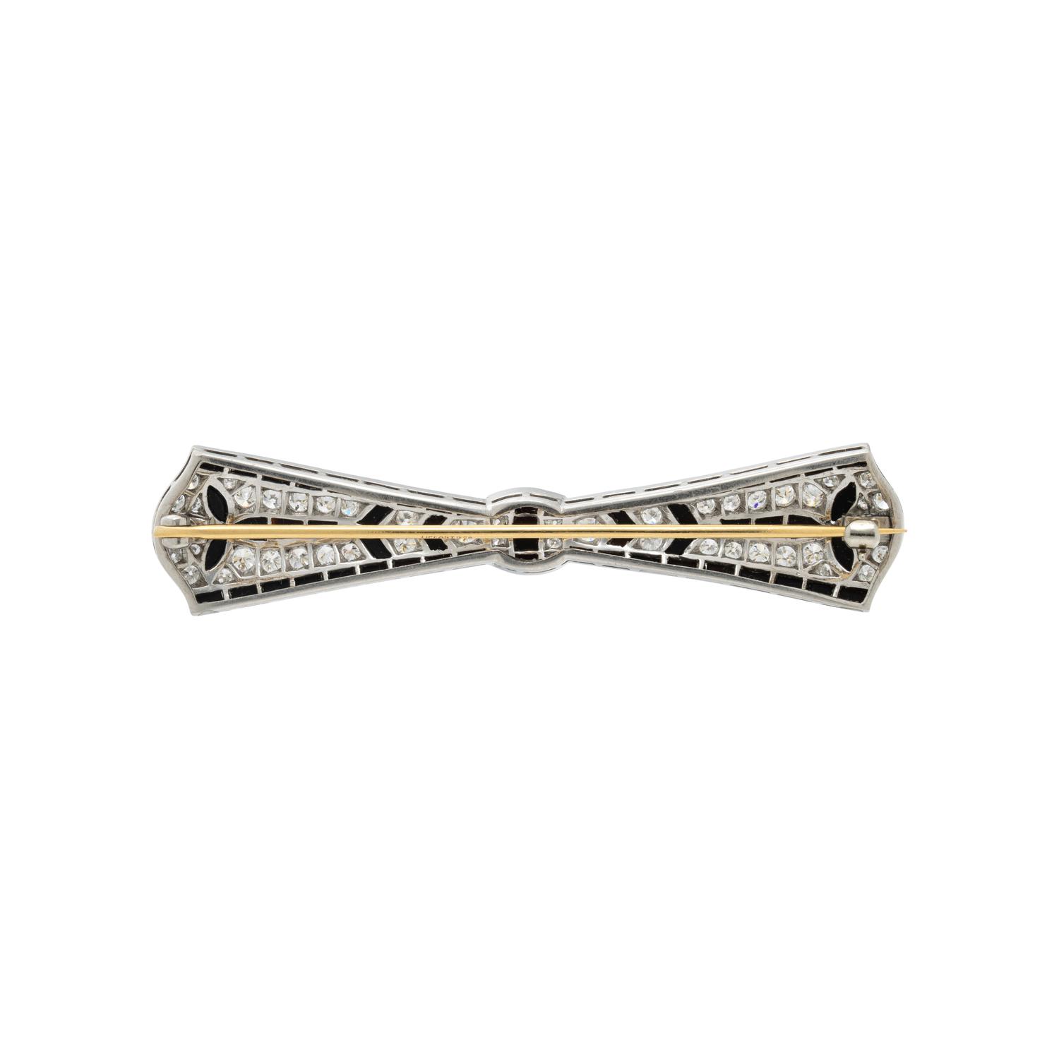 TIFFANY & CO., ART DECO, PLATINUM, DIAMOND, AND ONYX BOW BROOCH