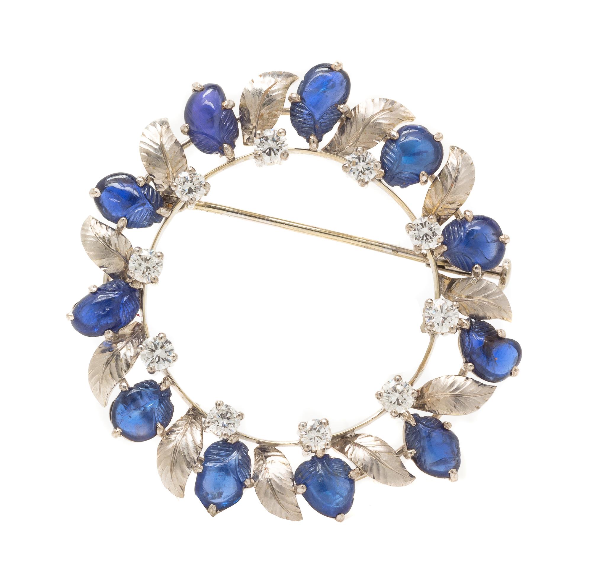 An 18 Karat White Gold, Sapphire and Diamond Wreath Motif Brooch, 8.10 dwts.