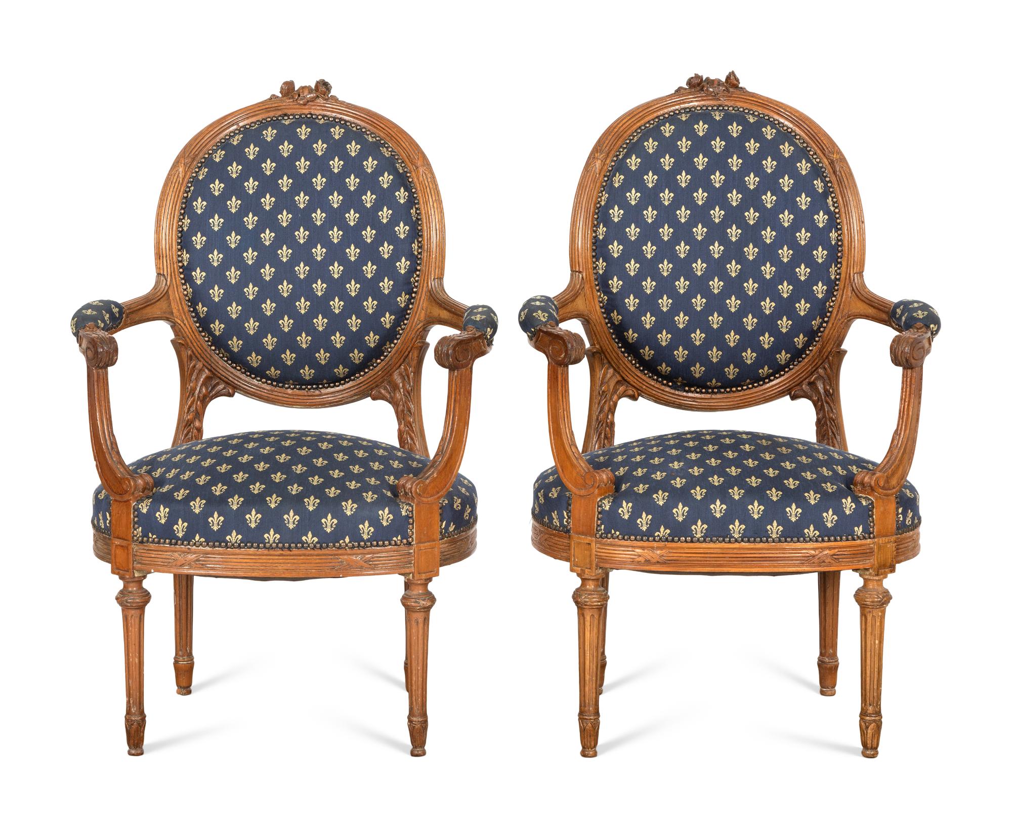 A Pair of Louis XVI Style Walnut Fauteuils
