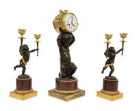 A French Gilt and Patinated Bronze and Rouge Marble Clock Garniture