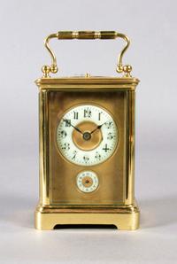 A French Brass Carriage Clock, Height over handle 6 1/4 inches.