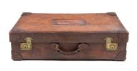 A Leather-Clad Travel Case Height 8 x width 29 3/4 x depth 17 inches.