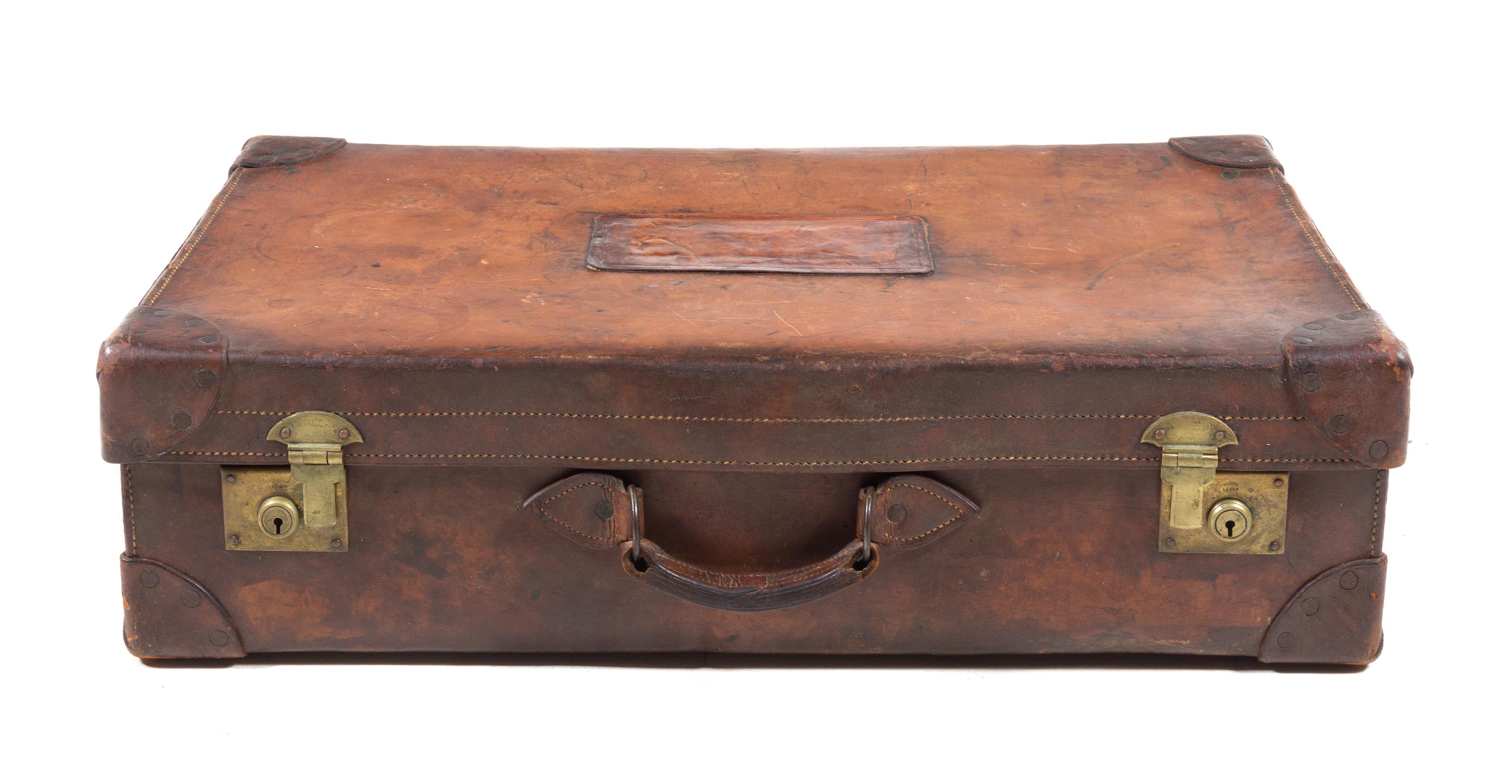 A Leather-Clad Travel Case Height 8 x width 29 3/4 x depth 17 inches.