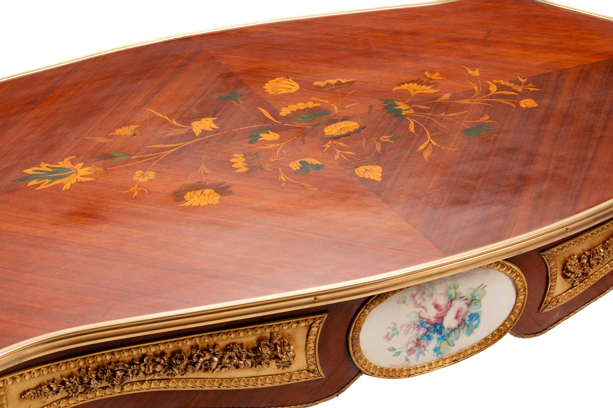 A Louis XV Style Gilt Bronze and Porcelain Mounted Marquetry Low Table