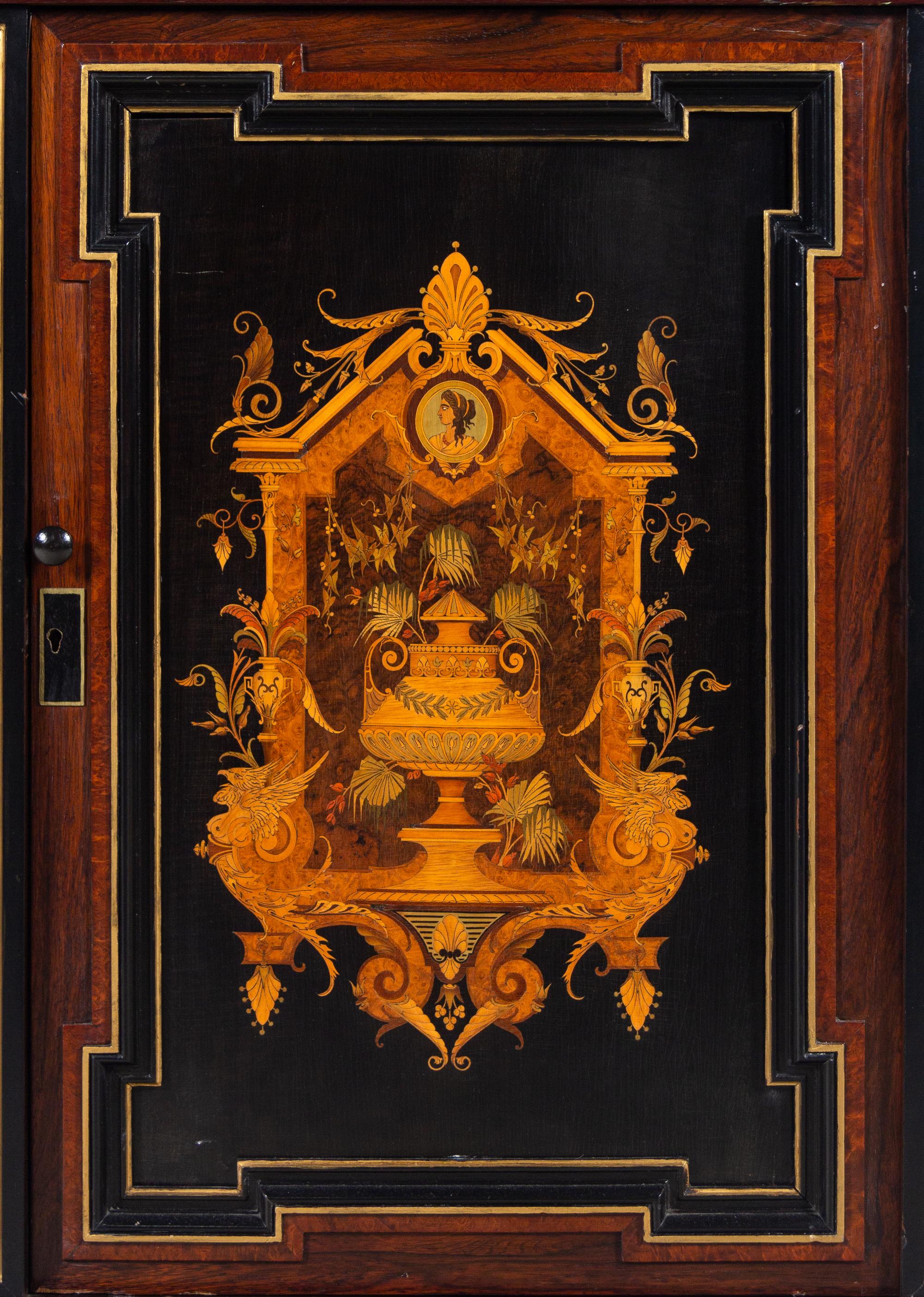 A Victorian Parcel Gilt Ebonized and Inlaid Rosewood Parlor Cabinet