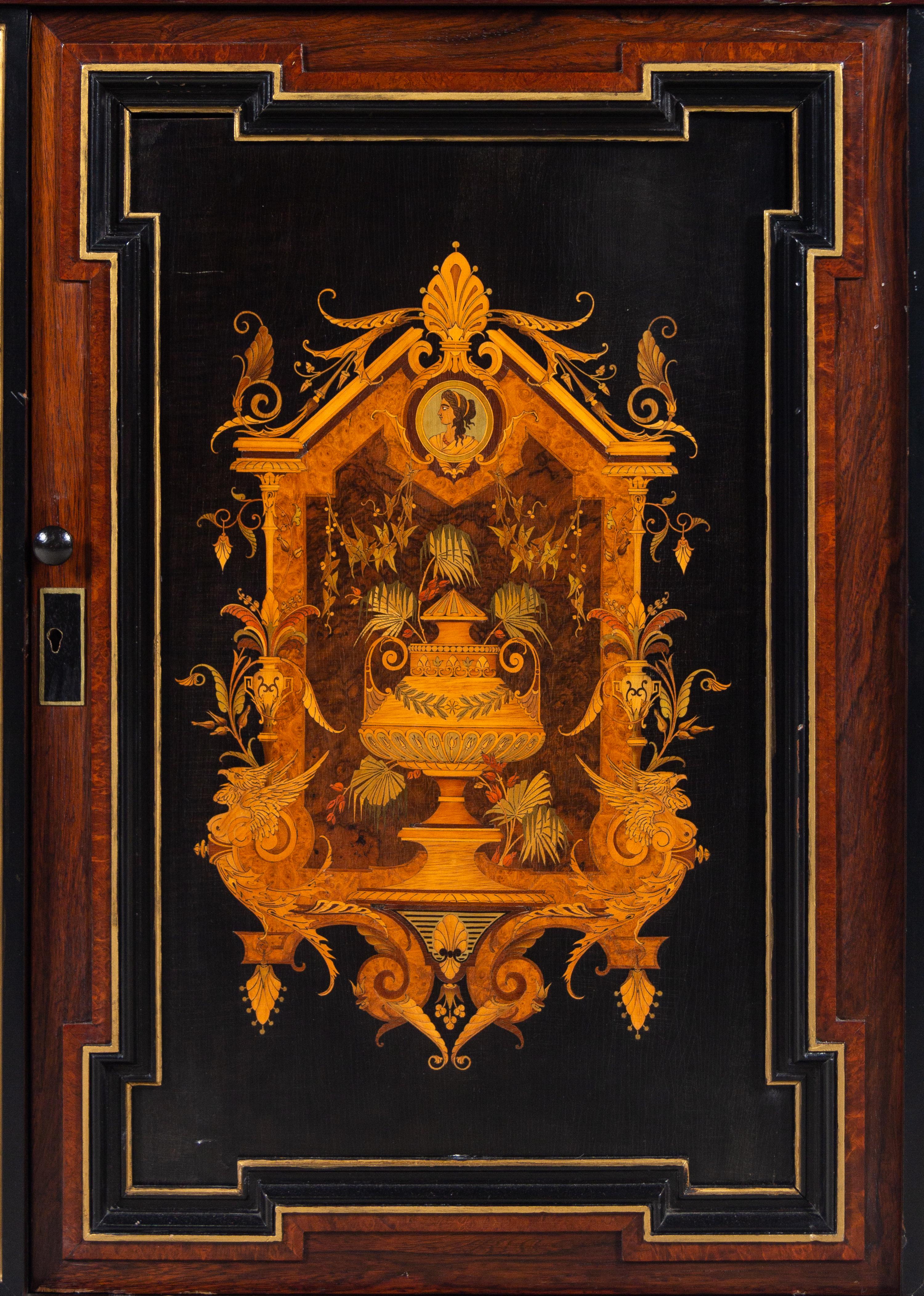 A Victorian Parcel Gilt Ebonized and Inlaid Rosewood Parlor Cabinet