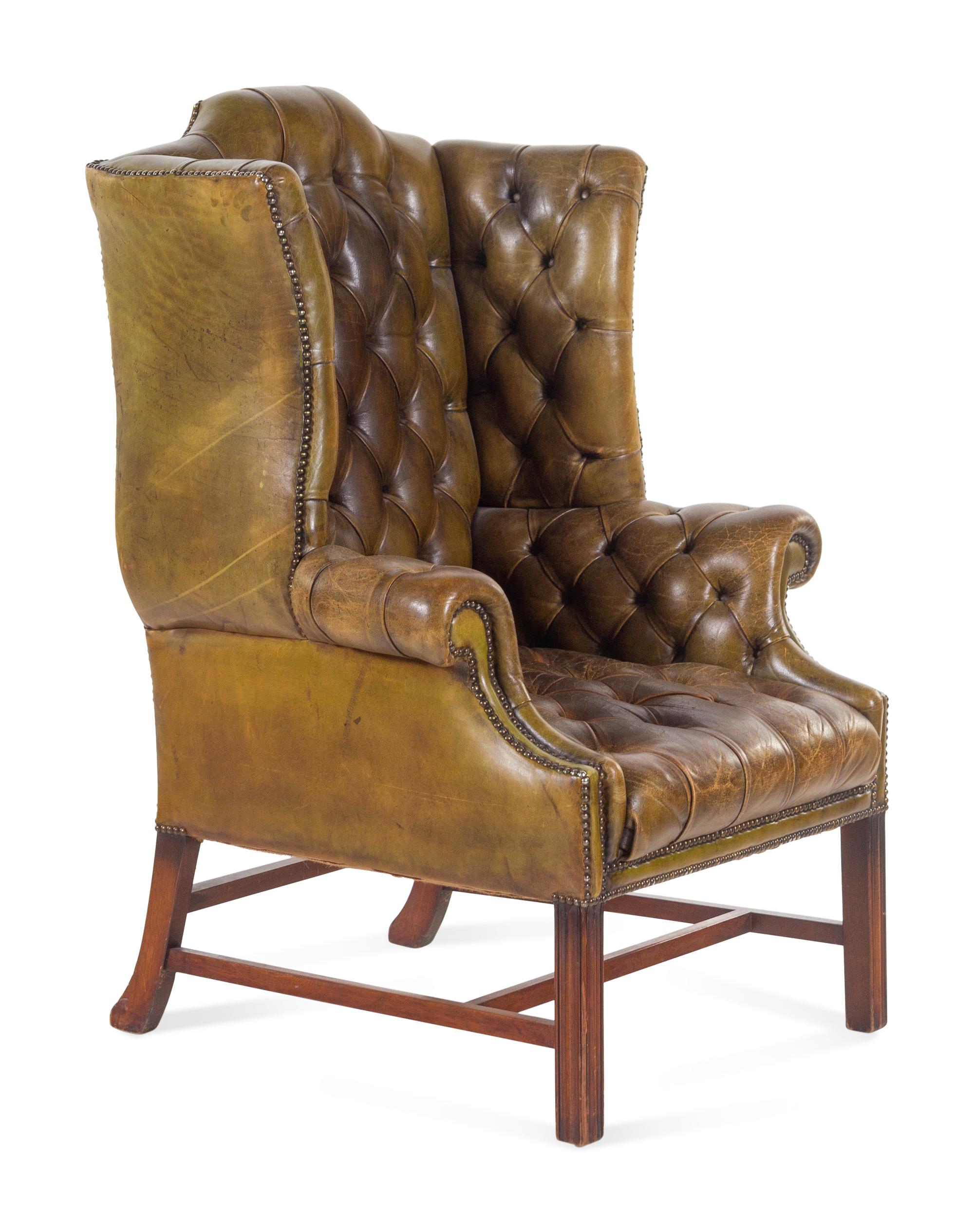 An English Leather Upholstered Mahogany Wingback Armchair