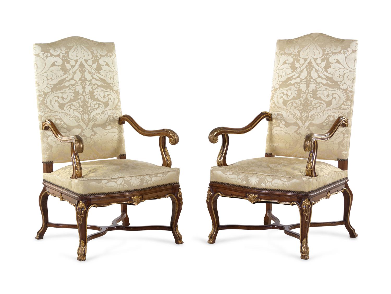 A Pair of Louis XV Style Carved and Parcel Gilt Walnut Fauteuils