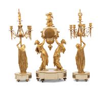 A Louis XVI Style Gilt Bronze and Marble Figural Clock Garniture